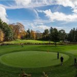 Panoramic view of a lush green golf course at Guilford Lakes Golf Course. Smooth