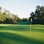 Panoramic view of a lush green golf course at Gulf Hills Golf Club. Smooth