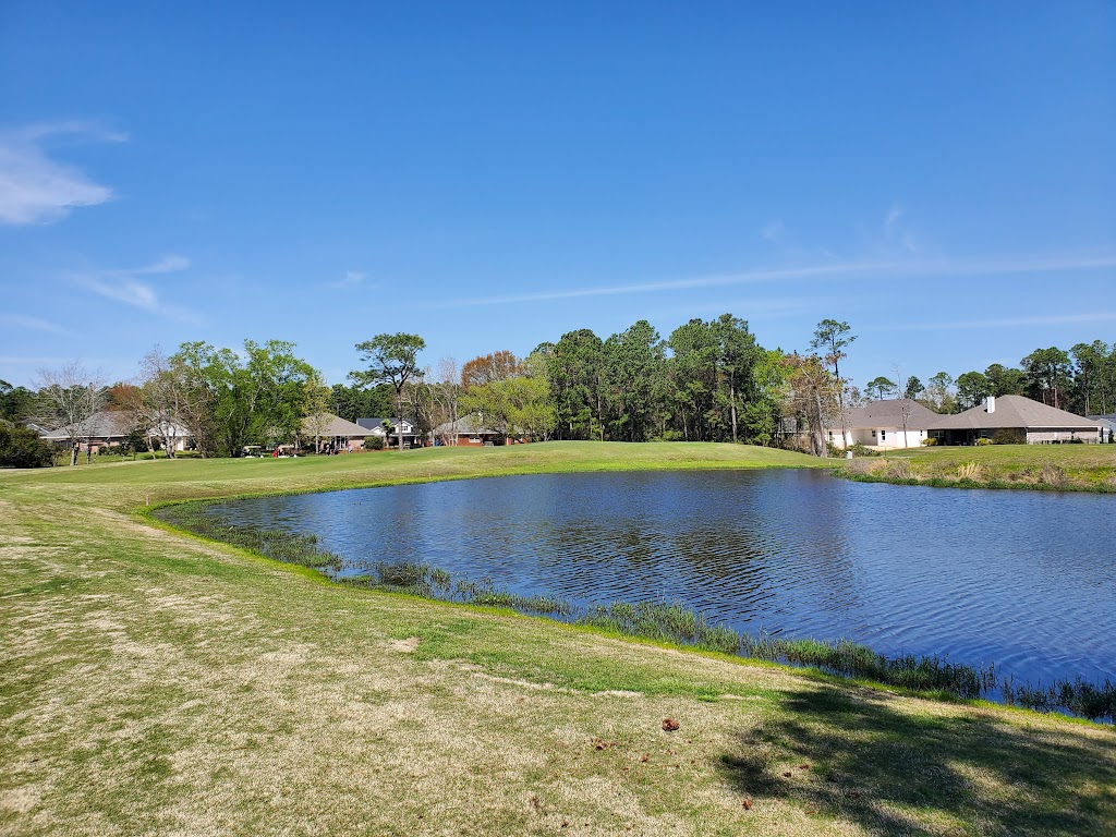 Panoramic view of a lush green golf course at Gulf Shores Golf Club. Smooth