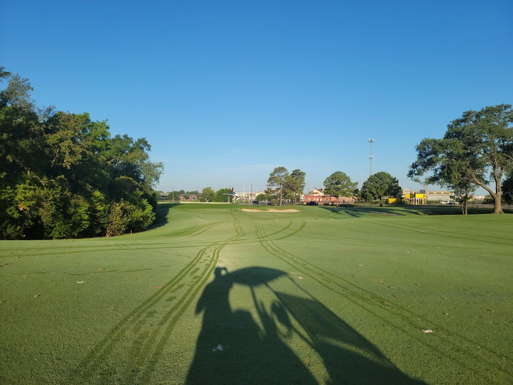 Panoramic view of a lush green golf course at Gus Wortham Park Golf Course. Smooth