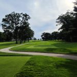 Panoramic view of a lush green golf course at Hackensack Golf Club. Smooth
