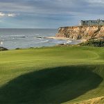 Panoramic view of a lush green golf course at Half Moon Bay Golf Links. Smooth