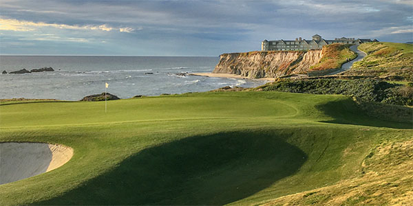 Panoramic view of a lush green golf course at Half Moon Bay Golf Links. Smooth