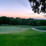 Panoramic view of a lush green golf course at Hallbrook Country Club. Smooth