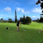 Panoramic view of a lush green golf course at Hamakua Country Club. Smooth