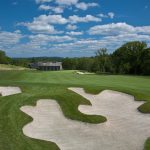 Panoramic view of a lush green golf course at Hamilton Farm Golf Club. Smooth