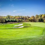 Panoramic view of a lush green golf course at Hampshire Greens Golf Course. Smooth