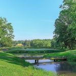 Panoramic view of a lush green golf course at Hanover Golf Club. Smooth