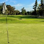Panoramic view of a lush green golf course at Hansen Dam Golf Course. Smooth