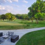 Panoramic view of a lush green golf course at Happy Hollow Club. Smooth