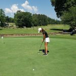green grass with the flag in the hole.