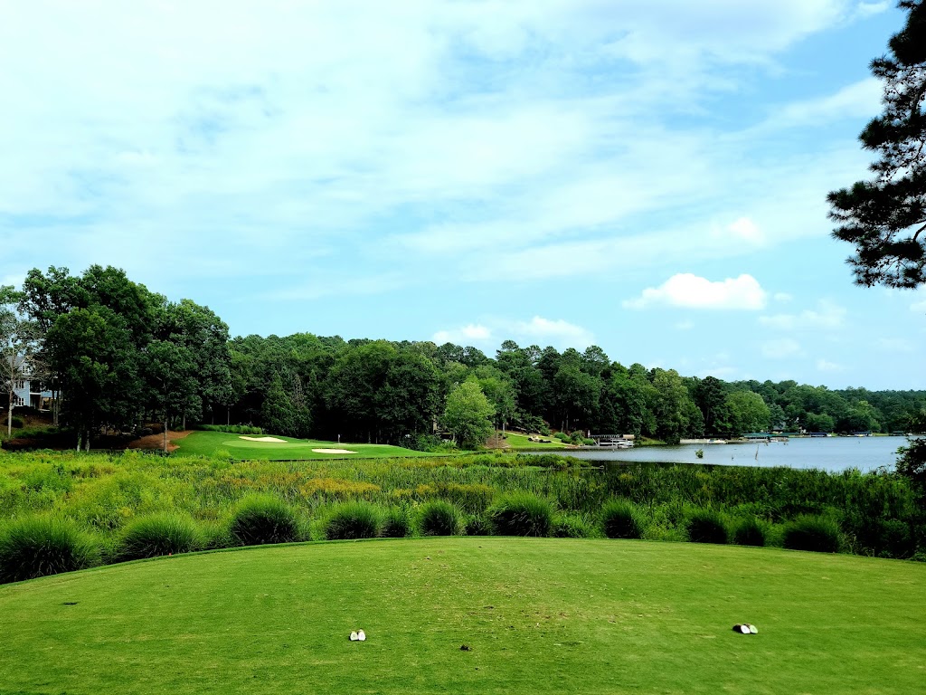 Panoramic view of a lush green golf course at Harbor Club on Lake Oconee. Smooth