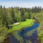 Panoramic view of a lush green golf course at Harbour Pointe Golf Club. Smooth
