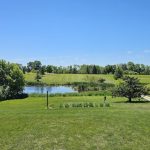 Panoramic view of a lush green golf course at Hardwood Hills Golf Course. Smooth