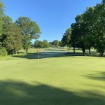 green grass with the flag in the hole.