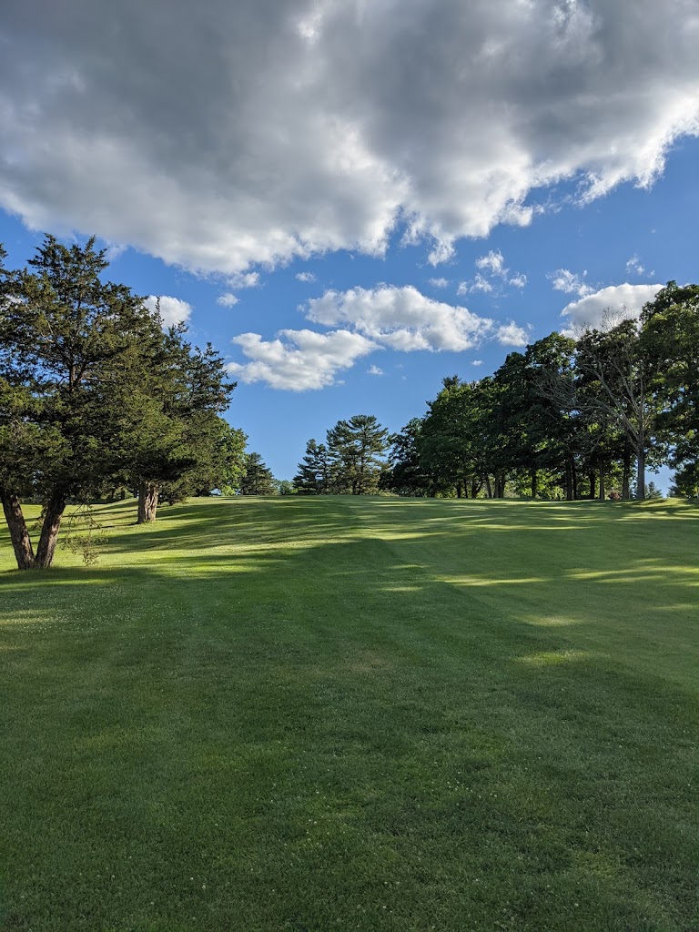 Panoramic view of a lush green golf course at Harrisville Golf Course. Smooth