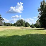 Panoramic view of a lush green golf course at Hartford Golf Course. Smooth