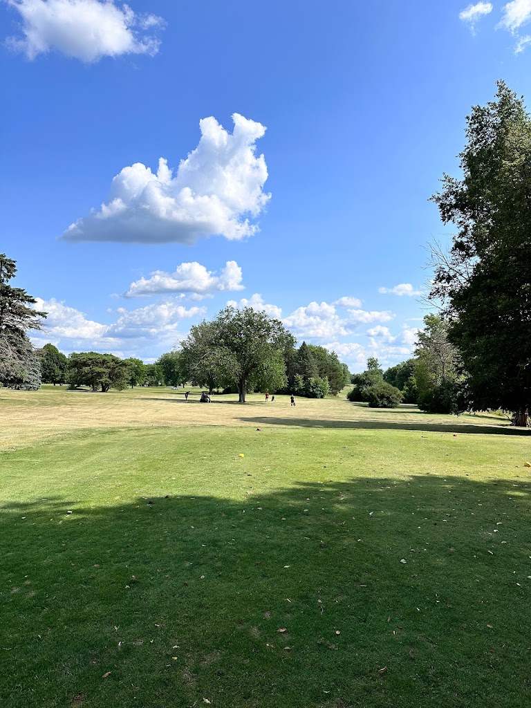 Panoramic view of a lush green golf course at Hartford Golf Course. Smooth
