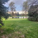 Panoramic view of a lush green golf course at Harvard Gulch Golf Course. Smooth