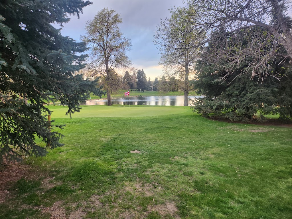 Panoramic view of a lush green golf course at Harvard Gulch Golf Course. Smooth