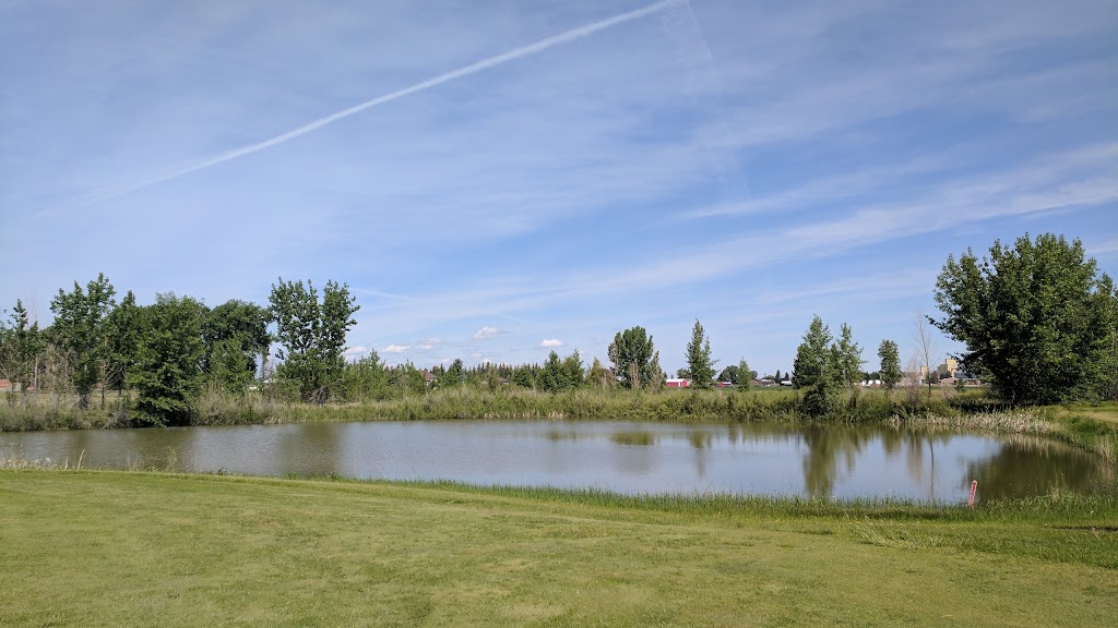 Panoramic view of a lush green golf course at Harvest Hills Golf Course. Smooth