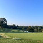Panoramic view of a lush green golf course at Hat Creek Golf Course. Smooth