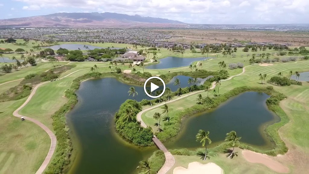 Panoramic view of a lush green golf course at Hawaii Golf Club Rentals. Smooth