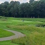 Panoramic view of a lush green golf course at Hawk Hollow Golf Course. Smooth