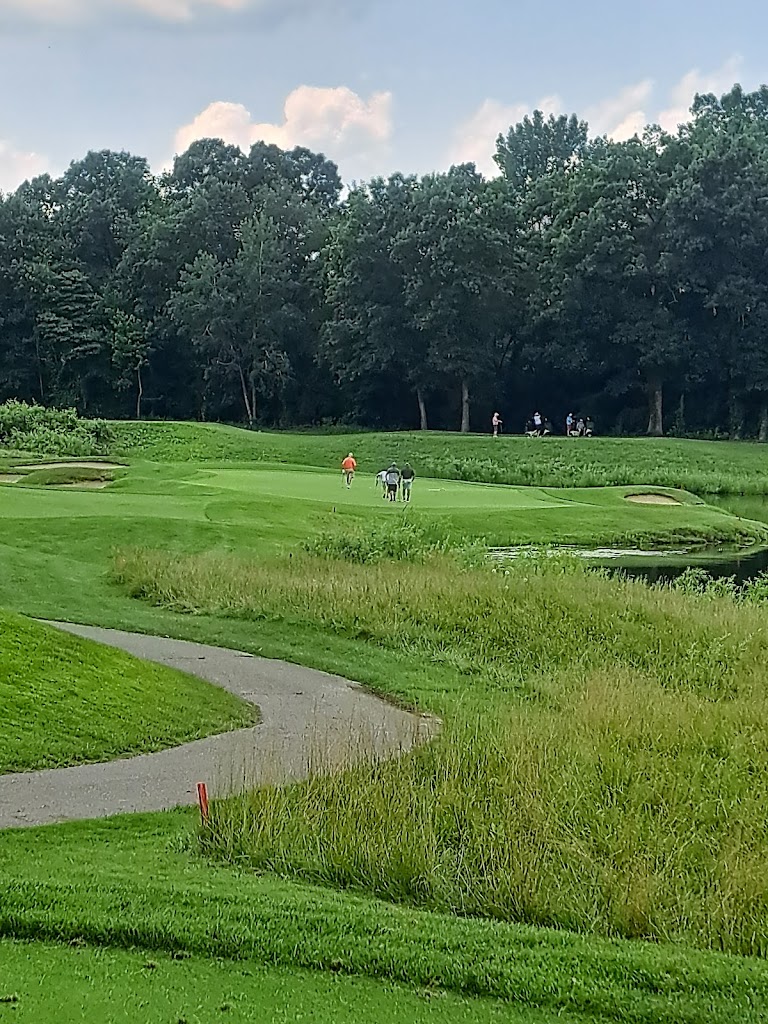 Panoramic view of a lush green golf course at Hawk Hollow Golf Course. Smooth