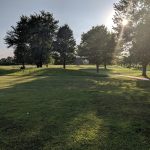 Panoramic view of a lush green golf course at Hawk's Tail of Greenfield. Smooth