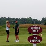green grass with the flag in the hole.