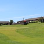 Panoramic view of a lush green golf course at Heart River Golf Course. Smooth