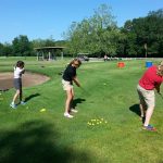 Panoramic view of a lush green golf course at Heart of America Golf Course. Smooth