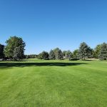 Panoramic view of a lush green golf course at Heather Gardens Golf Club. Smooth