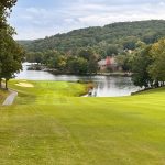 Panoramic view of a lush green golf course at Heatherhurst Golf Course. Smooth