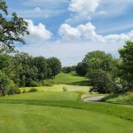 Panoramic view of a lush green golf course at Heritage Bluffs Golf Club. Smooth