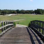 Panoramic view of a lush green golf course at Heritage Isles Golf & Country Club. Smooth