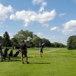 Panoramic view of a lush green golf course at Heritage Oaks Golf Club. Smooth