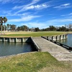 Panoramic view of a lush green golf course at Heritage Oaks Golf Club. Smooth