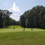 Panoramic view of a lush green golf course at Heritage Oaks Golf Course. Smooth