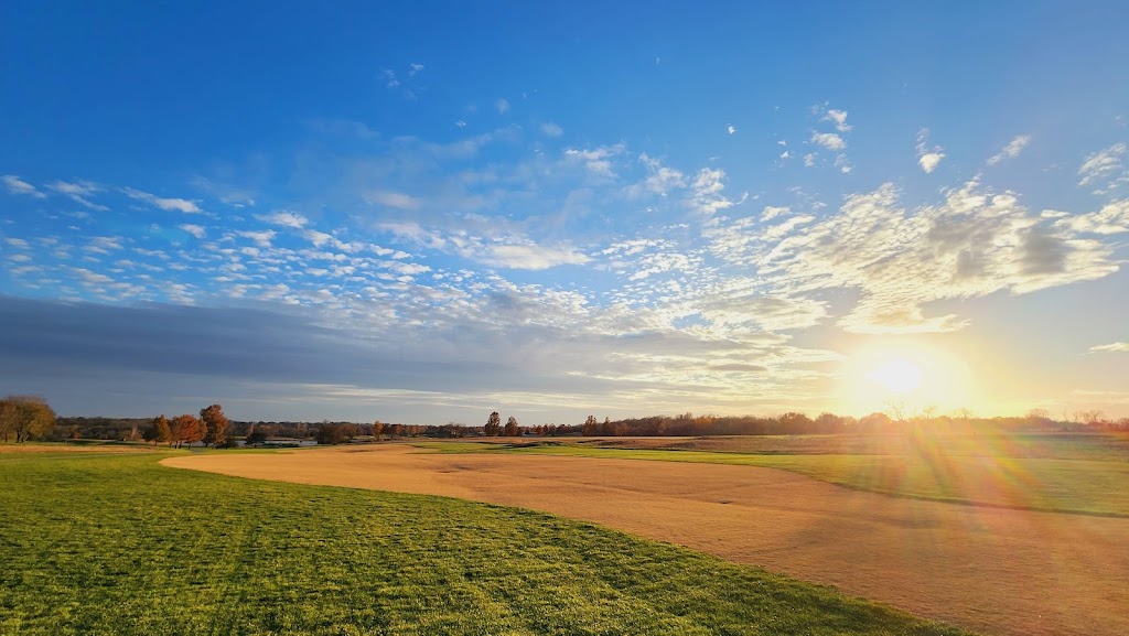 Panoramic view of a lush green golf course at Heritage Park Golf Course. Smooth
