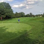 Panoramic view of a lush green golf course at Herndon Centennial Golf Course. Smooth