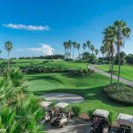 Panoramic view of a lush green golf course at Heron Creek Golf & Country Club. Smooth