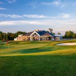 Panoramic view of a lush green golf course at Heron Glen Golf Course. Smooth