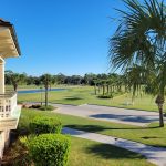 Panoramic view of a lush green golf course at Heron Point by Pete Dye. Smooth