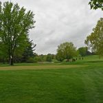 Panoramic view of a lush green golf course at Hiawatha Golf Club. Smooth