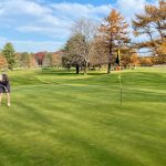 green grass with the flag in the hole.