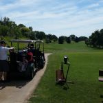 Panoramic view of a lush green golf course at Hidden Acres Golf Course. Smooth