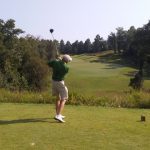 green grass with the flag in the hole.