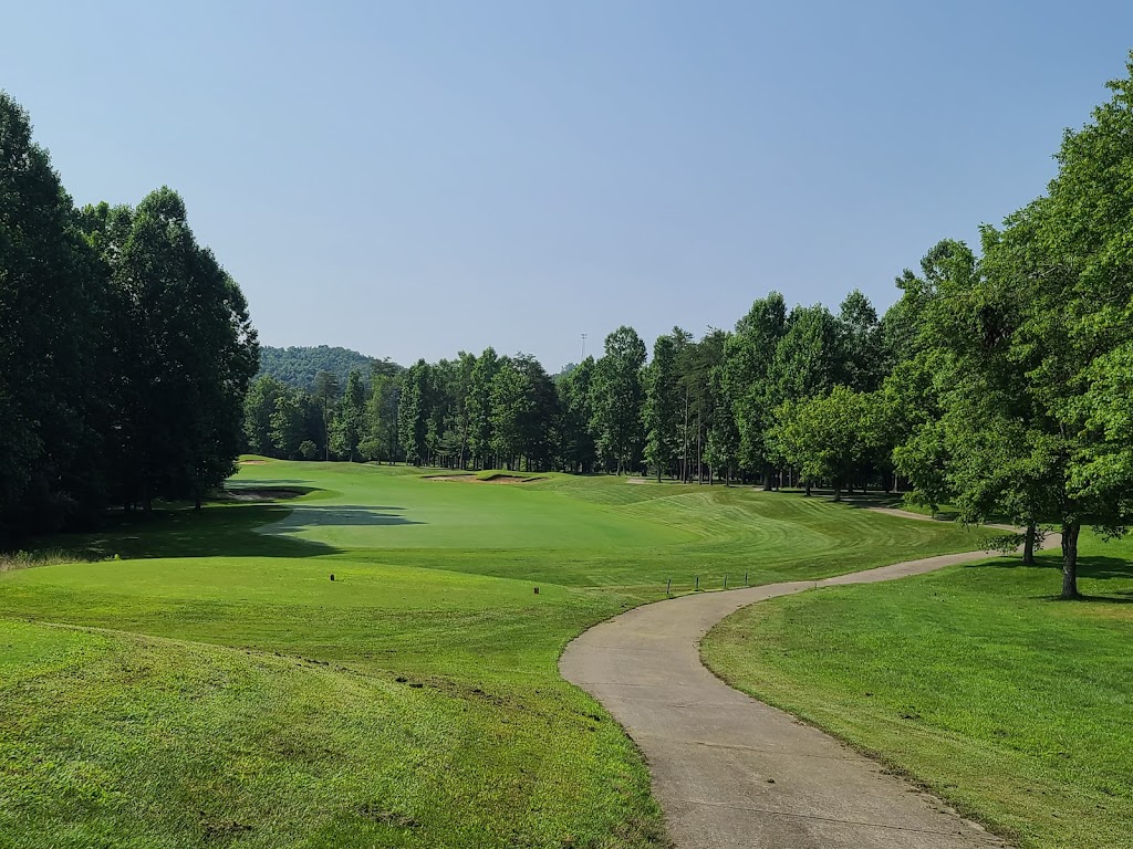 Panoramic view of a lush green golf course at Hidden Cove Golf Course. Smooth
